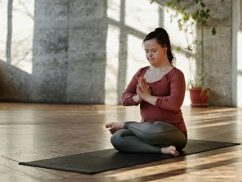 Spacious, calm room with a yoga mat, prepared for a workout session.